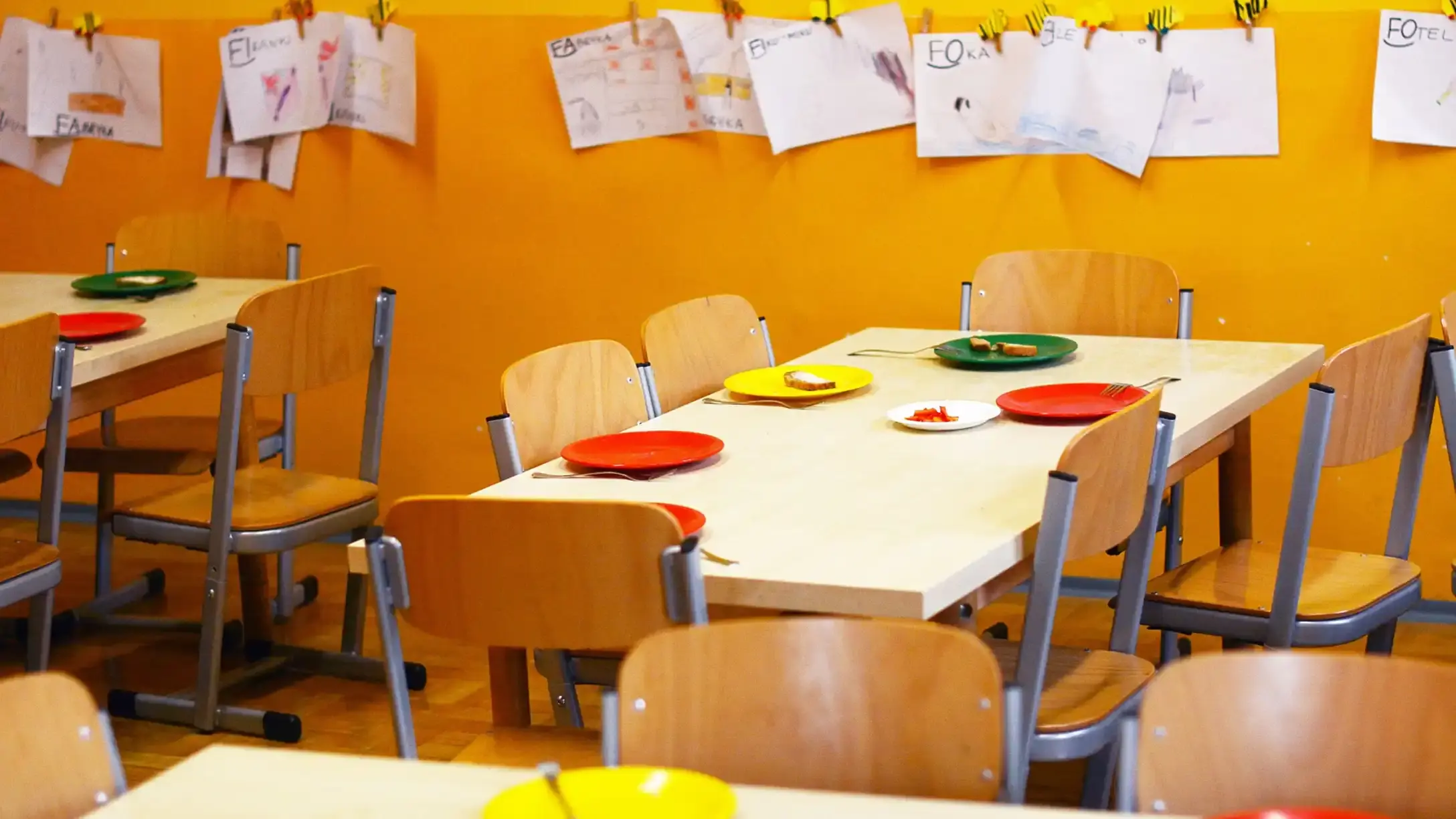 A school dinner hall with tables set