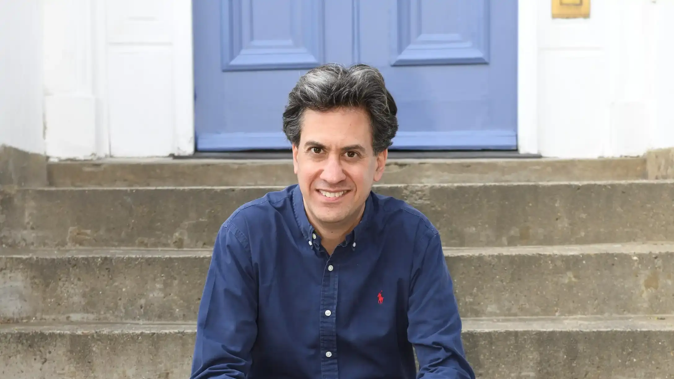 Ed Miliband sat on a set of steps