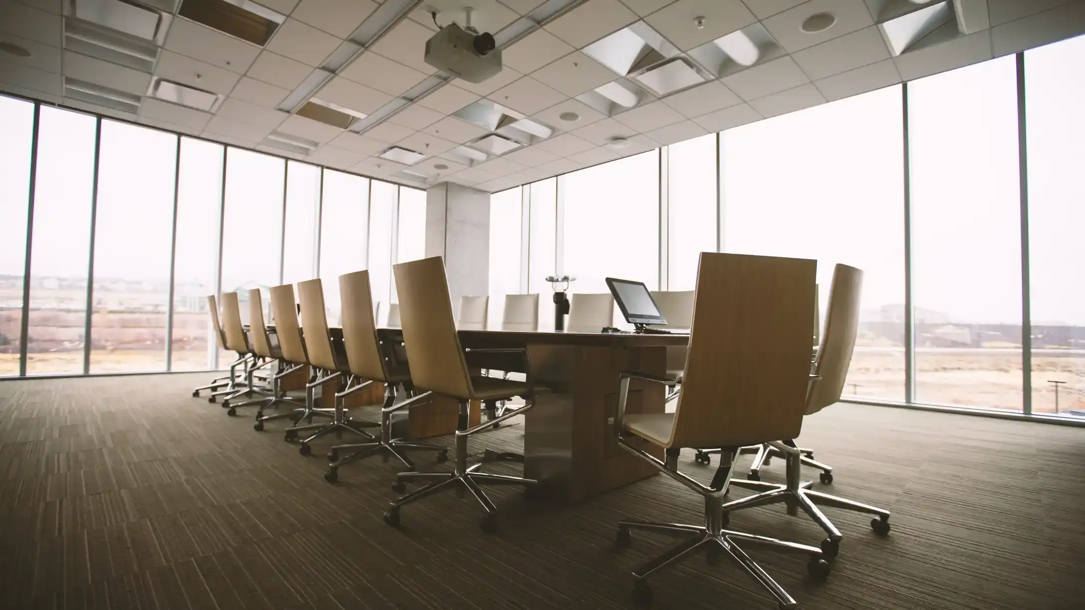 A meeting room with chairs set around a table