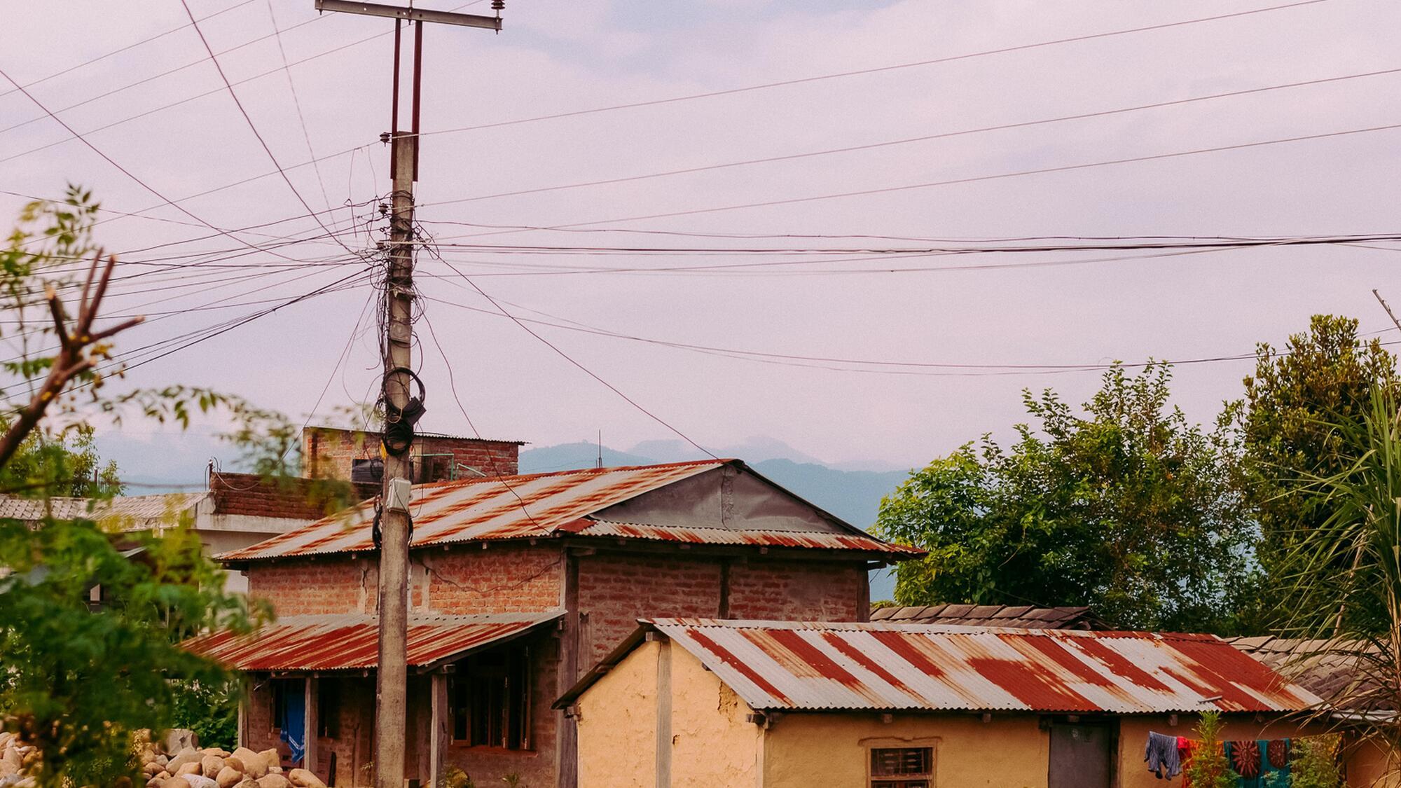 Small houses in Nepal under an electricity line in the countryside