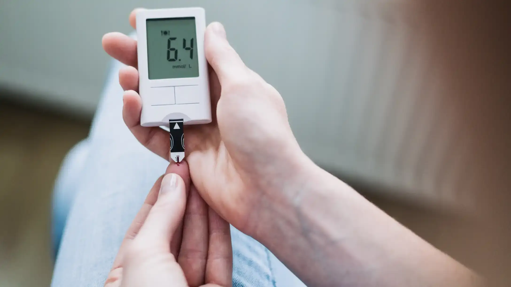 Woman Measuring Blood Sugar with a Glucose Meter