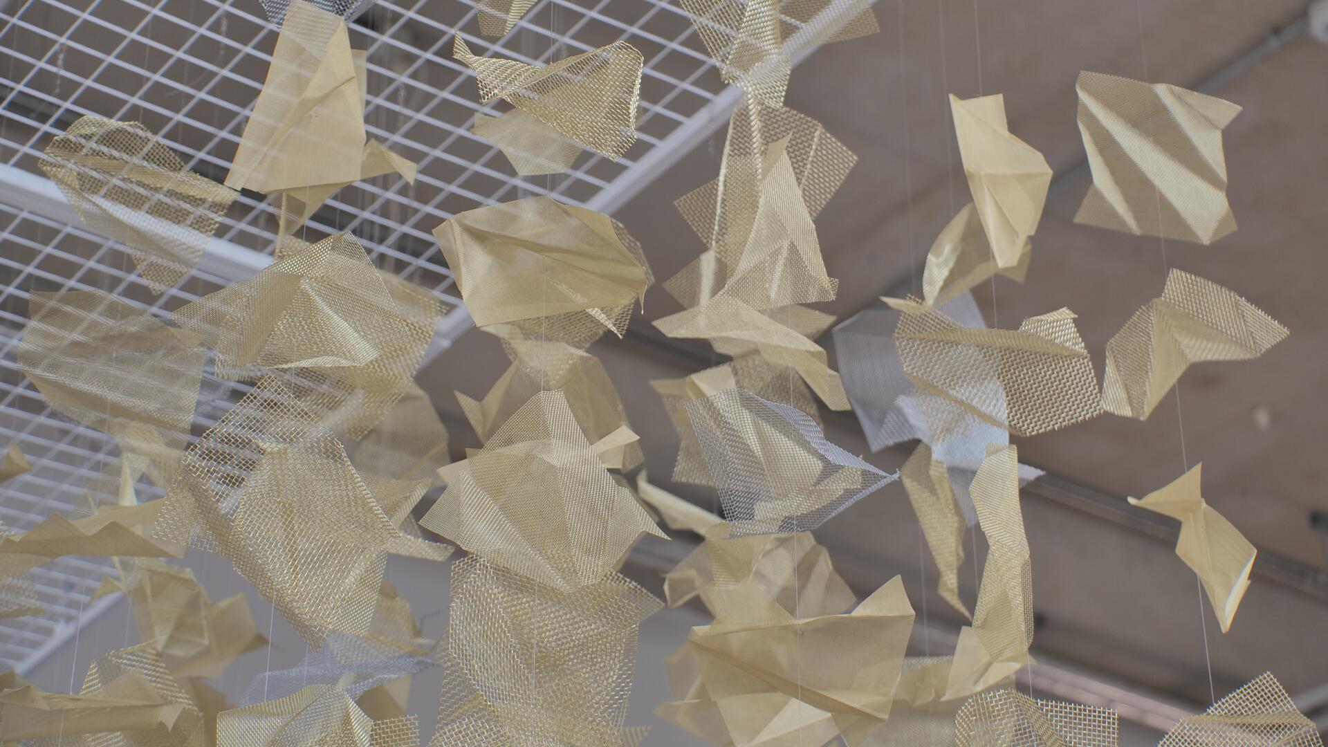 Woven brass and steel sheets bent and formed into an exhibit that shows frailty as we age