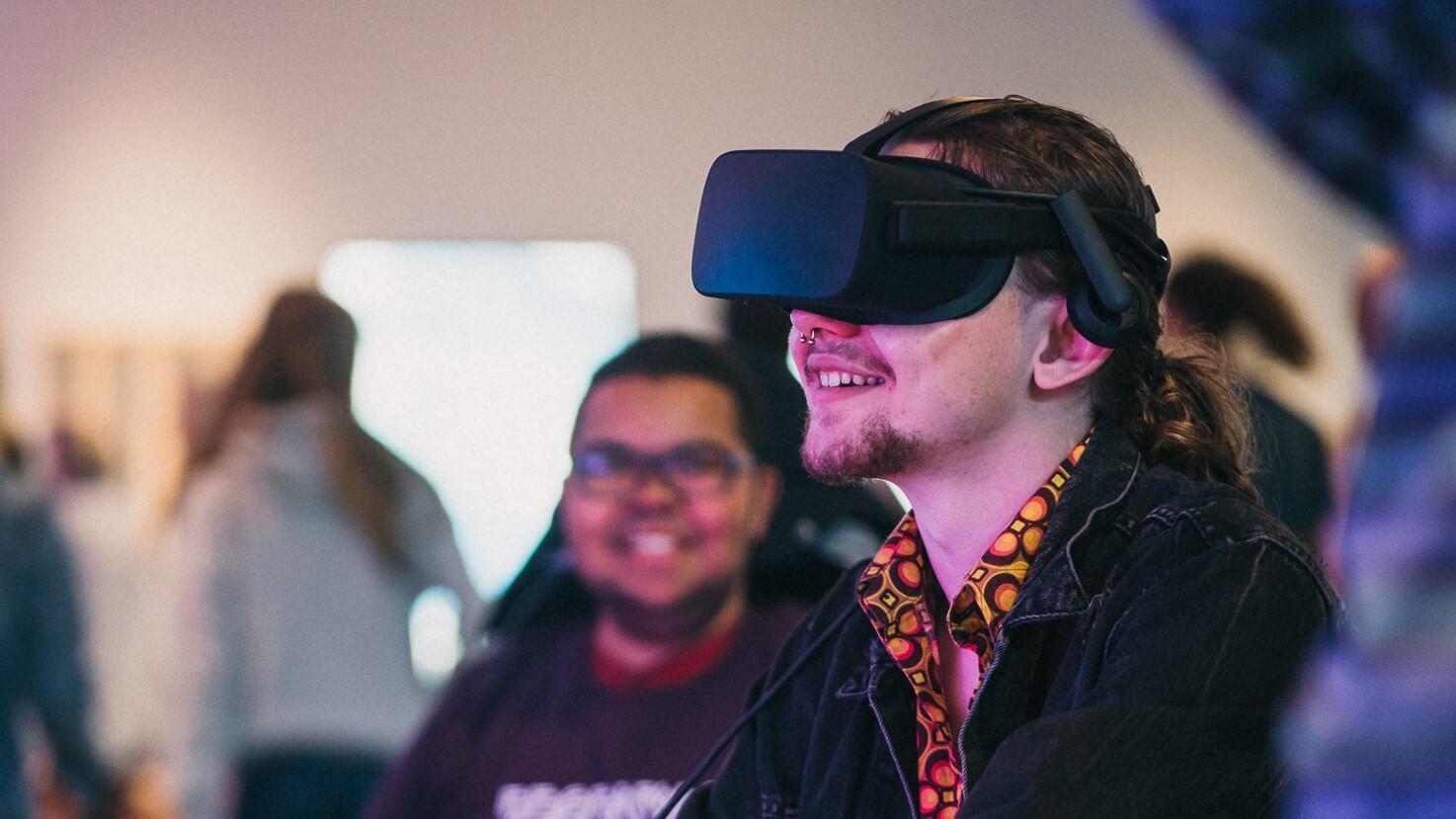 A man sitting and wearing a VR headset