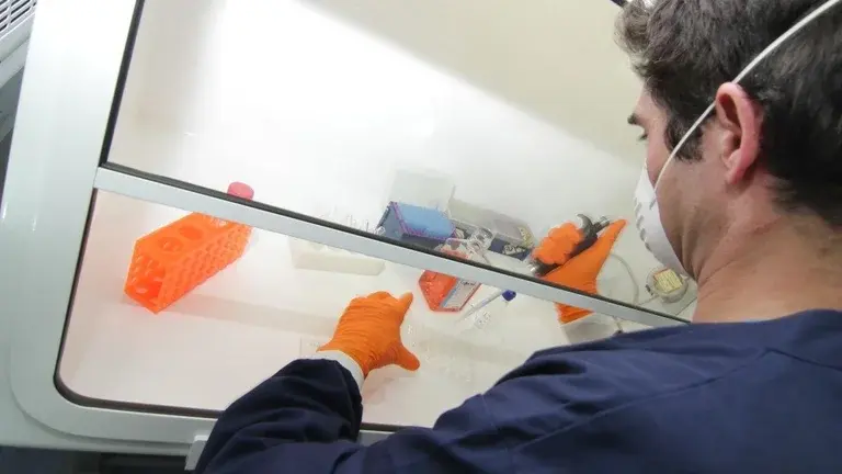 A medical researcher using a pipette