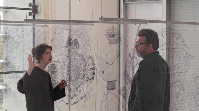 Image of Sheffield-based artist, Jessica Heywood talking to Phil Withington in front of their art installation