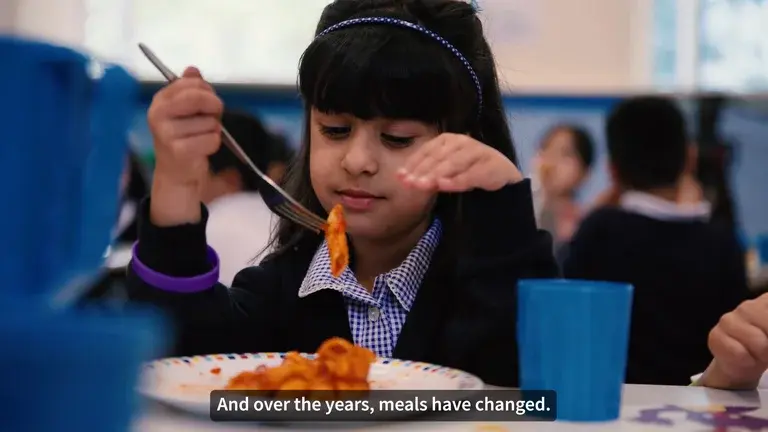 A photo of a school girl eating her school meal