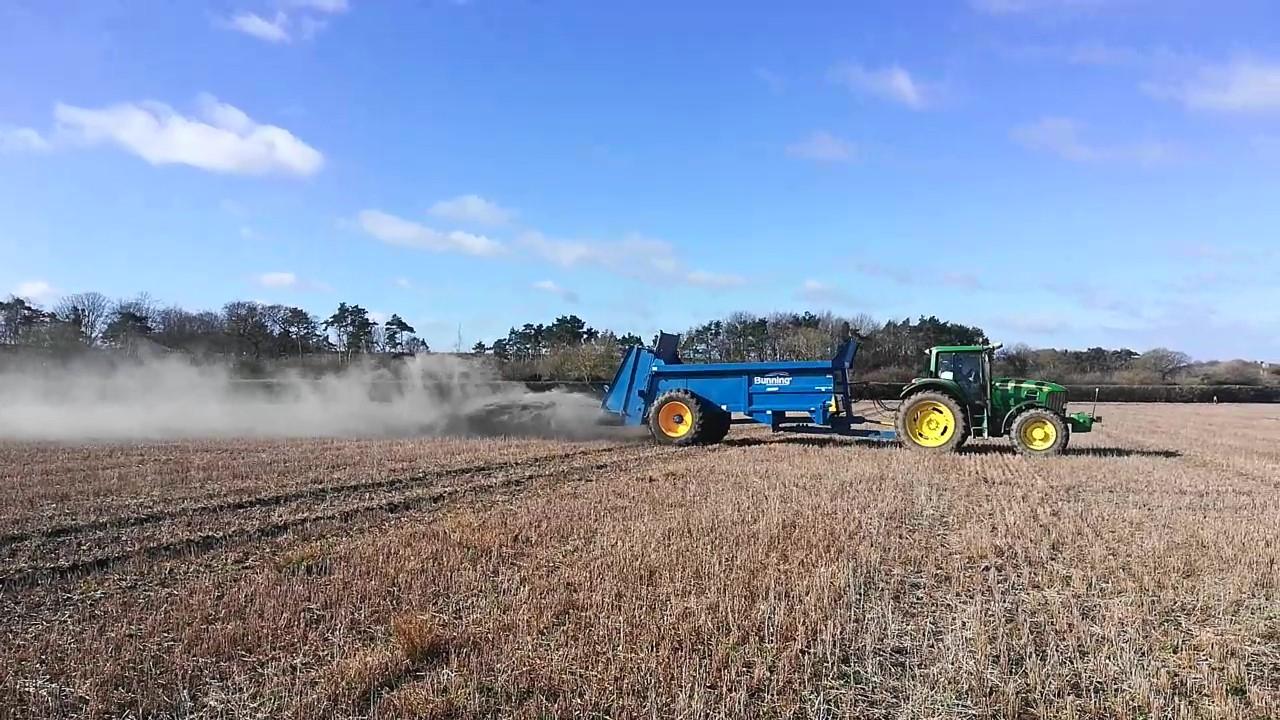 Tractor applying basalt to a field