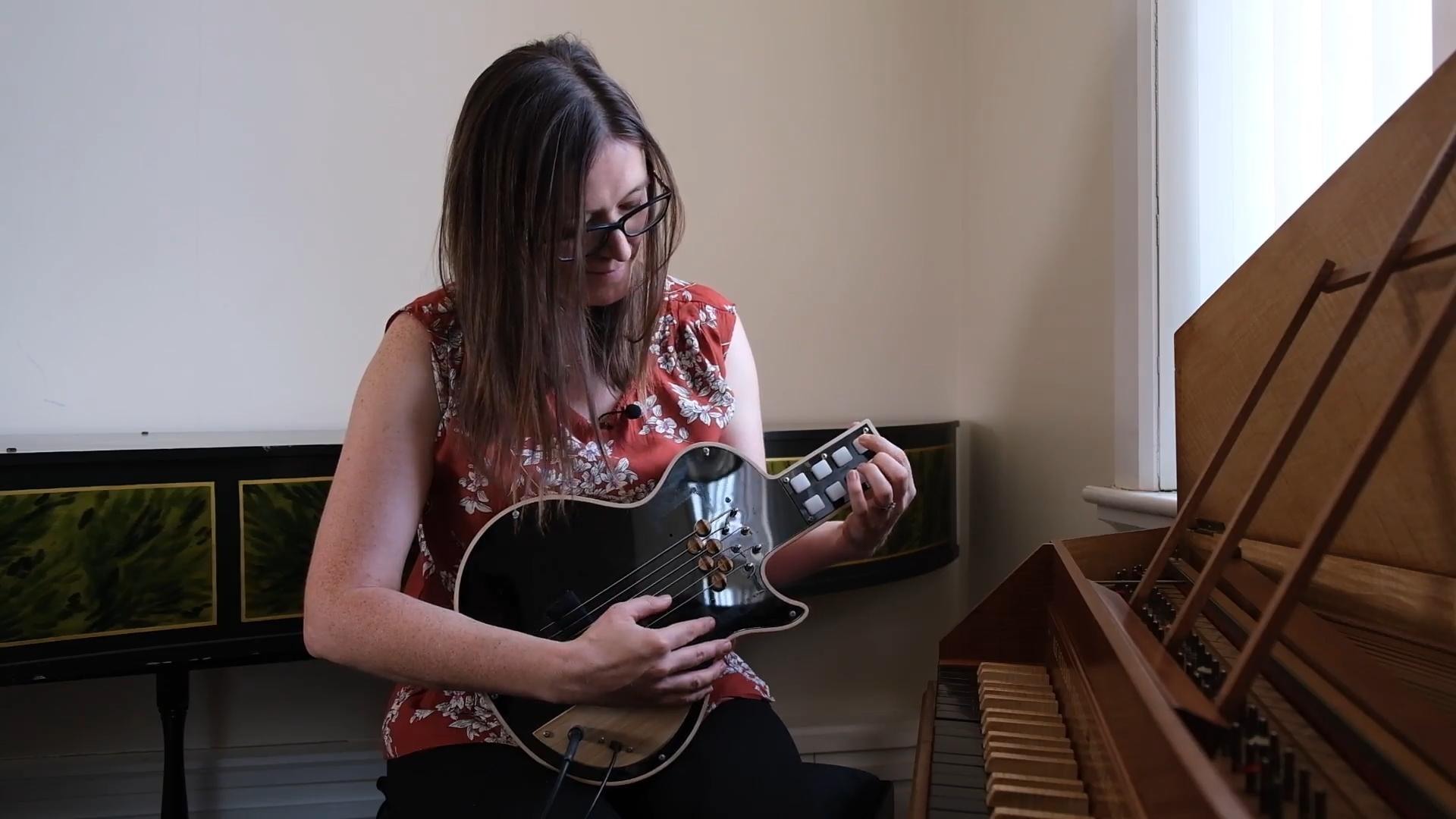 Jennifer MacRitchie playing an adapted guitar