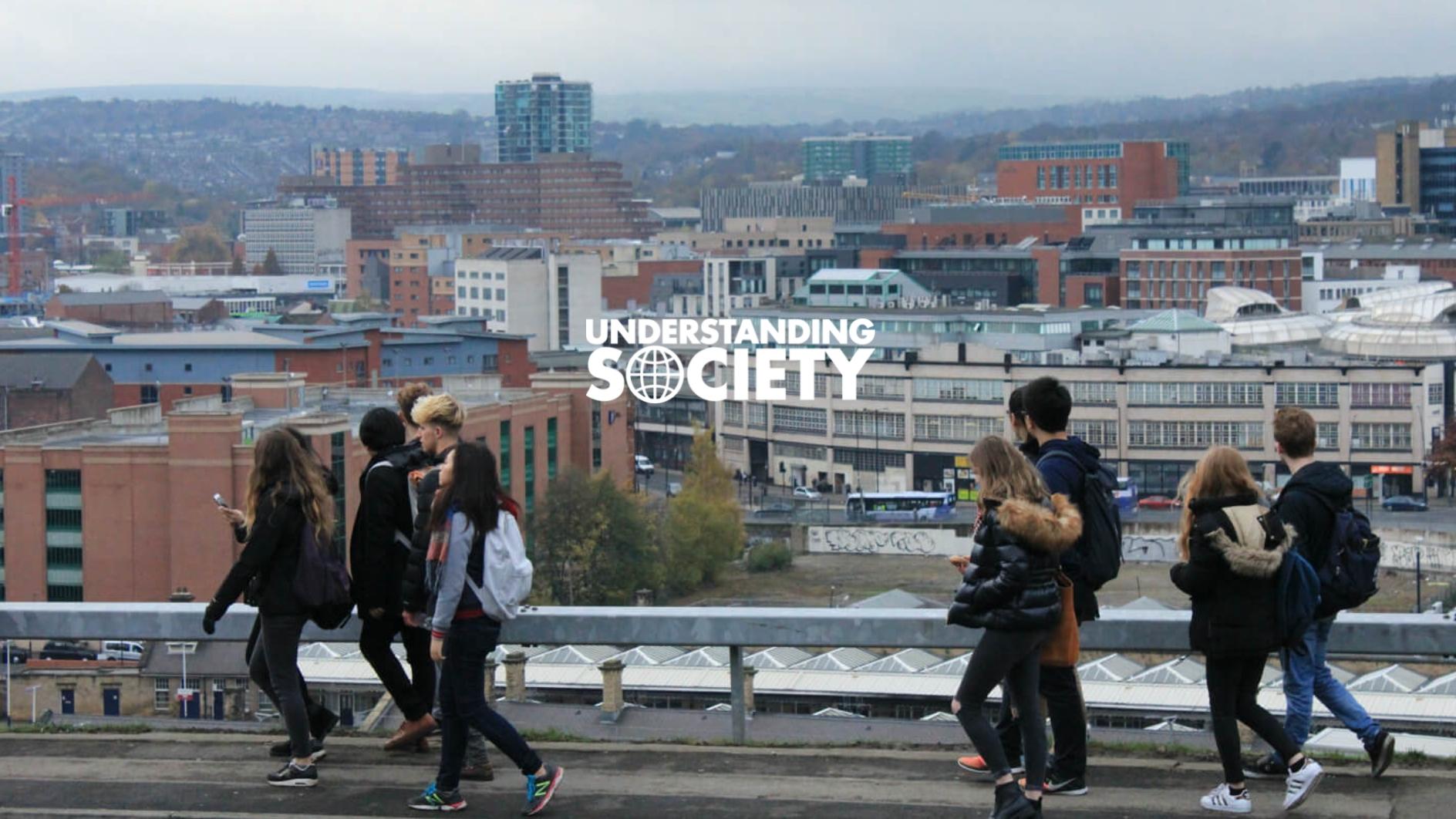 Young people walking along a path overlooking the city of Sheffield