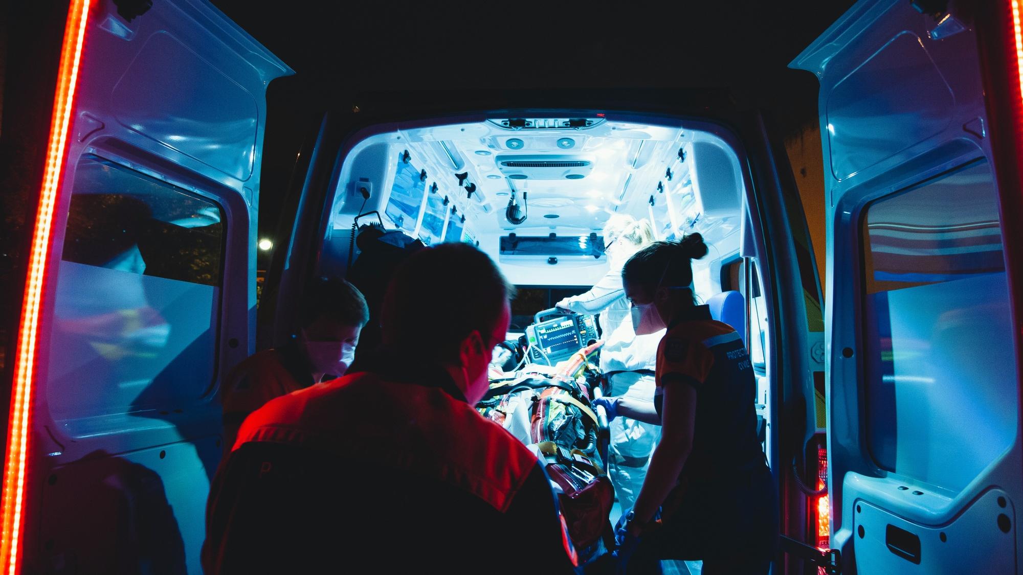 Medical staff treating a patient in an ambulance