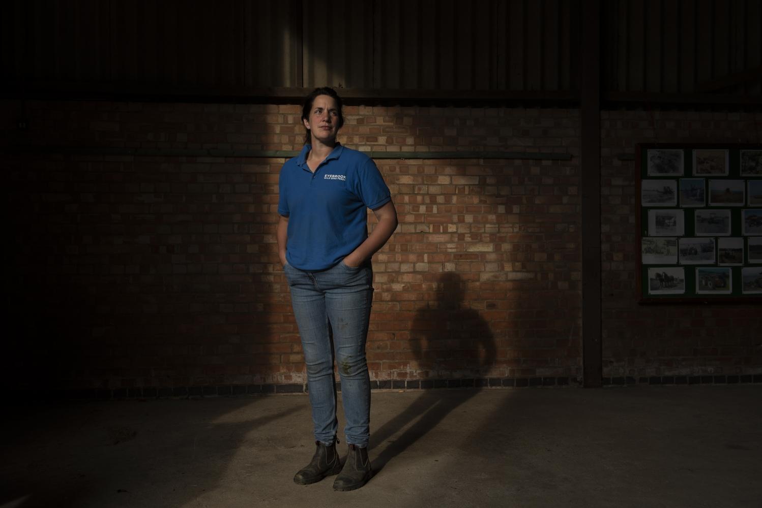 A woman standing in a stables