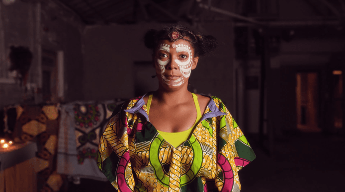 A women wearing white face paint