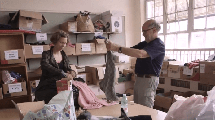Jules Holroyd and colleague boxing up clothes for refugees