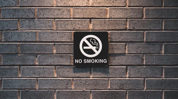 No smoking signage on a brick wall
