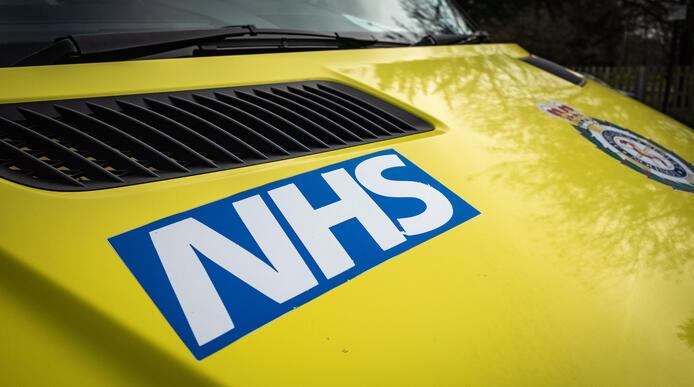Photo of ambulance zoomed in NHS logo