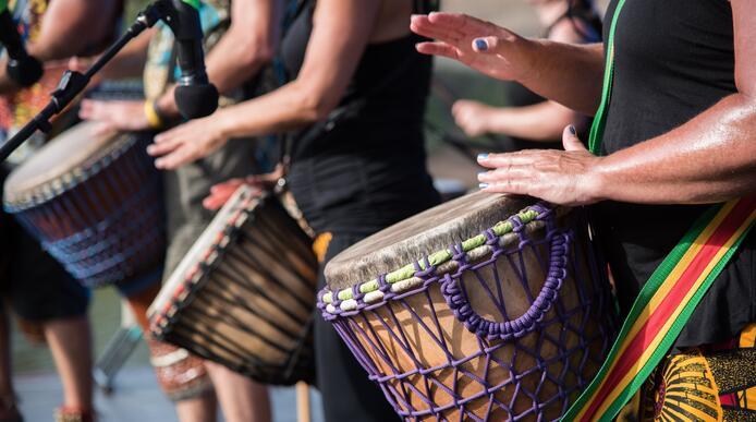 A group of people playing African drums